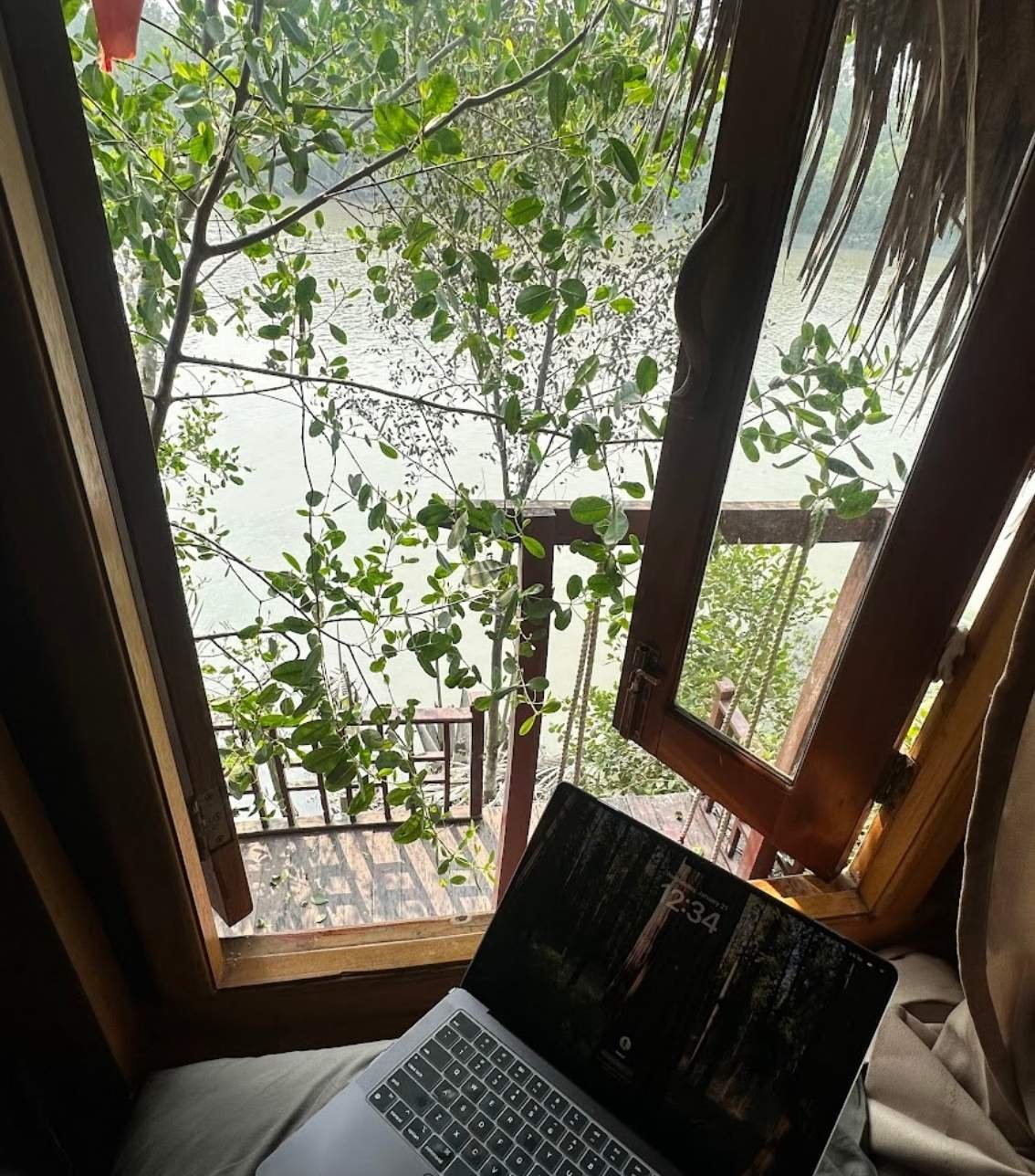 Mo and Rikta working from a jungle treehouse with a river view